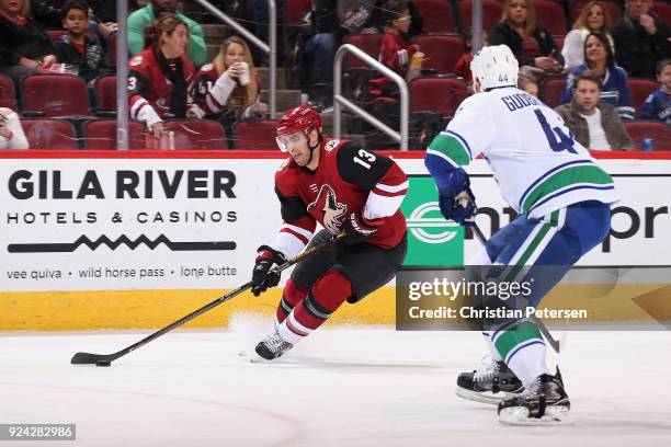 Freddie Hamilton of the Arizona Coyotes skates with the puck ahead of Erik Gudbranson of the Vancouver Canucks during the first period of the NHL...