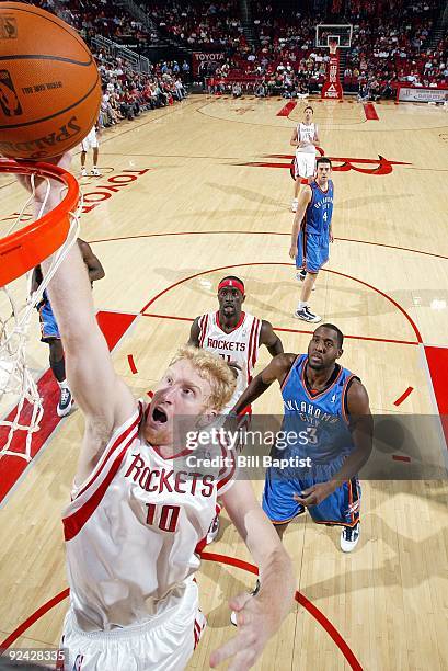 Chase Budinger of the Houston Rockets shoots a layup past D.J. White of the Oklahoma City Thunder during a preseason game at Toyota Center on October...