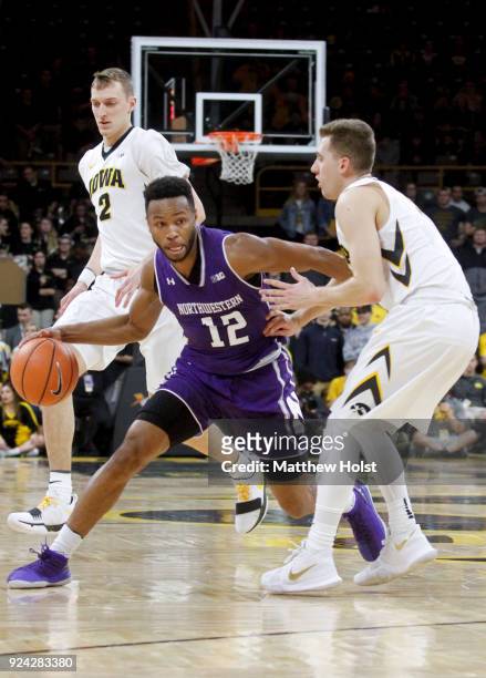 Guard Isiah Brown of the Northwestern Wildcats brings the ball down the court in the first half against guard Jordan Bohannon of the Iowa Hawkeyes,...