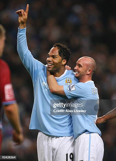 Joleon Lescott of Manchester City celebrates with Stephen Ireland after scoring his goal during the Carling Cup 4th Round match between Manchester...