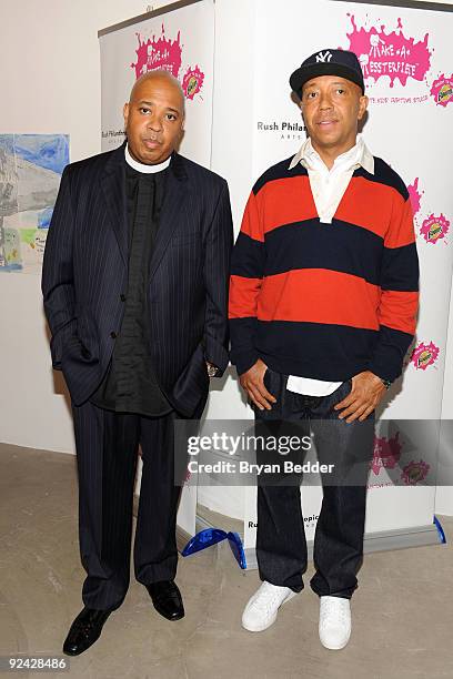 Russell Simmons and Rev Run attend the unveiling of the "Building Bounty-ful Bridges" National Arts mural at the Rush Art Gallery on October 28, 2009...