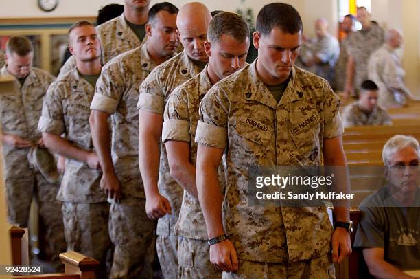 Marines pay their respects during a memorial service for Staff Sgt. Aaron J. Taylor in the Chapel at Camp Pendleton on October 28, 2009 in Oceanside,...