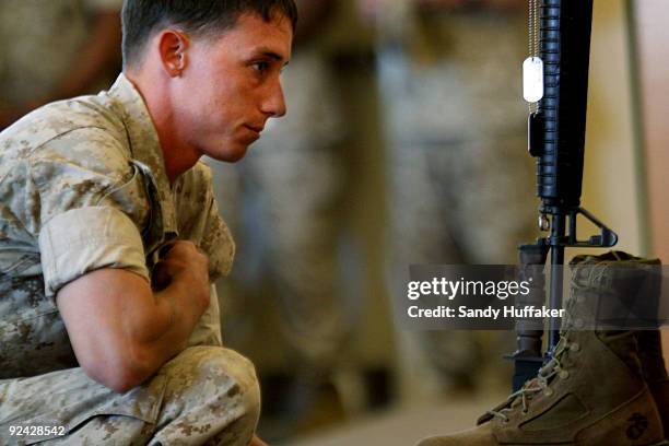 Marine pays his respects during a memorial service for Staff Sgt. Aaron J. Taylor in the Chapel at Camp Pendleton on October 28, 2009 in Oceanside,...