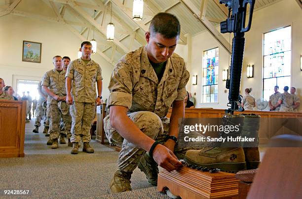 Marines pay their respects during a memorial service for Staff Sgt. Aaron J. Taylor in the Chapel at Camp Pendleton on October 28, 2009 in Oceanside,...