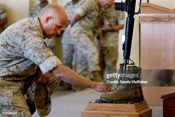 Marine Staff Sgt. Bryce Cannon pays his respects during a memorial service for Staff Sgt. Aaron J. Taylor in the Chapel at Camp Pendleton on October...