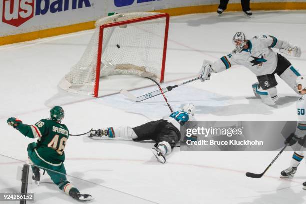 Jared Spurgeon of the Minnesota Wild scores the game winning goal in overtime against Brent Burns and goalie Martin Jones of the San Jose Sharks at...