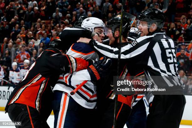 Linesman Shane Heyer breaks up a fight between Cam Fowler of the Anaheim Ducks and Oscar Klefbom of the Edmonton Oilers during the game on February...