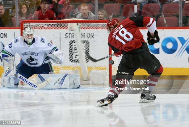 Christian Dvorak of the Arizona Coyotes attempts a shot on goalie Jacob Markstrom of the Vancouver Canucks during the second period at Gila River...