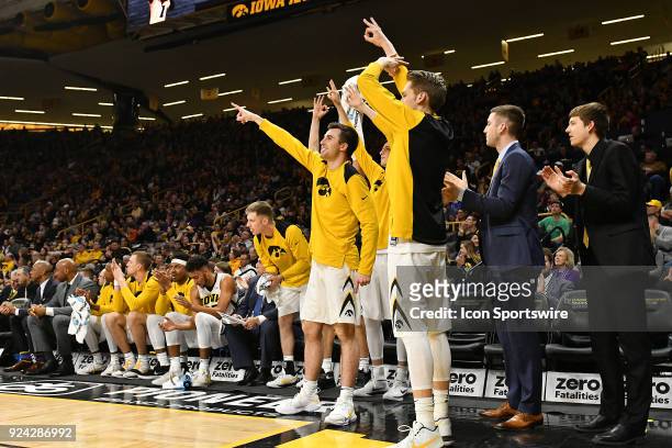 The Iowa bench reacts to a three-point shot by Iowa guard Jordan Bohannon in the first half during a Big Ten Conference basketball game between the...