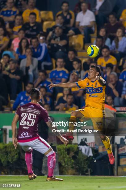 Lucas Zelarayan of Tigres heads the ball while observed by Mario Osuna of Morelia during the 9th round match between Tigres UANL and Morelia as part...