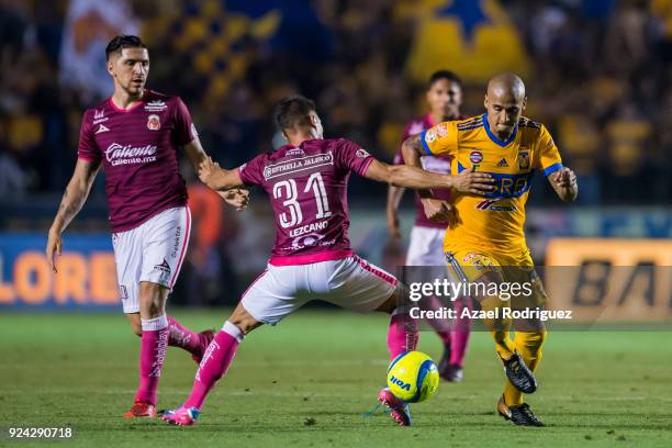 Luis Rodriguez of Tigres fights for the ball with Gaston Lezcano of Morelia during the 9th round match between Tigres UANL and Morelia as part of the...