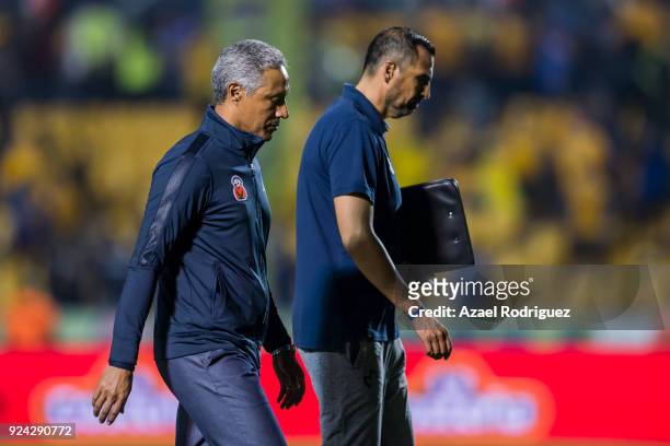Roberto Hernandez, coach of Morelia, talks to his staff as he leaves the field at the end of the 9th round match between Tigres UANL and Morelia as...