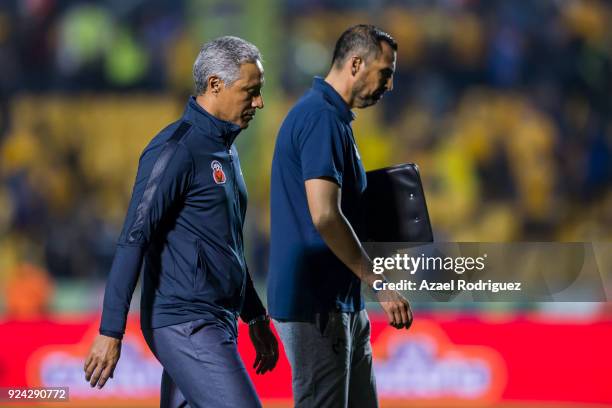 Roberto Hernandez, coach of Morelia, talks to his staff as he leaves the field at the end of the 9th round match between Tigres UANL and Morelia as...