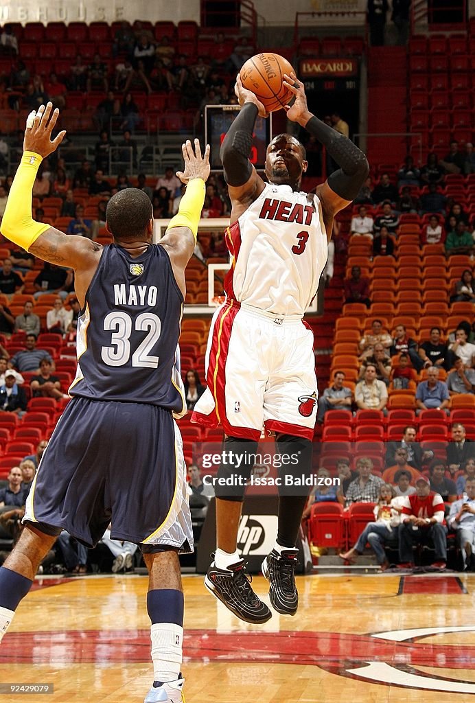 Dwyane Wade of the Miami Heat shoots a jump shot over O.J. Mayo of ...