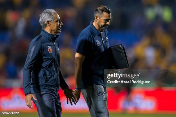 Roberto Hernandez, coach of Morelia, talks to his staff as he leaves the field at the end of the 9th round match between Tigres UANL and Morelia as...