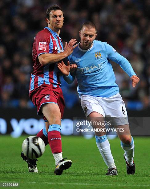 Manchester City's English midfielder Michael Johnson vies with Scunthorpe United's English forward Paul Hayes during their Carling Cup fourth round...