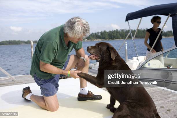Author John Irving at his summer home with dog Dickens and wife Janet on August 18, 2009 in Pointe au Baril, Ontario, Canada.