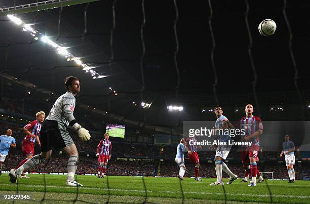 Joleon Lescott of Manchester City scores his goal past Joe Murphy of Scunthorpe United during the Carling Cup 4th Round match between Manchester City...