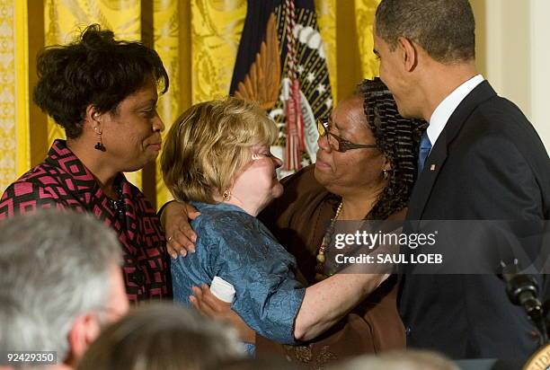 Louvon Harris looks on as her sister Betty Byrd Boatner , both sisters of James Byrd, Jr., embraces Judy Shepard , mother of Matthew Shepard, as US...