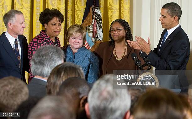 President Barack Obama applauds the sisters of James Byrd, Jr., Betty Byrd Boatner and Louvon Harris , and the parents of Matthew Shepard, Judy...