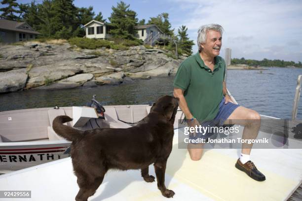 Author John Irving at his summer home with dog Dickens on August 18, 2009 in Pointe au Baril, Ontario, Canada.