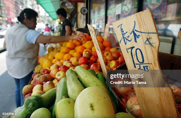 Woman shops for fruit July 8, 2002 in the Chinatown section of New York City. The Rebuild Chinatown Initiative, that was announced today, will study...