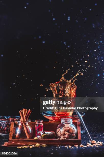 espresso coffee cup with a dynamic splash on a dark background. frozen motion drink photography with copy space - sugary coffee drink stock pictures, royalty-free photos & images