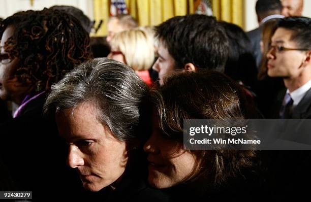 Karen Dixon and her spouse Nan Schaffer attend a White House reception where U.S. President Barack Obama delivered remarks on the enactment of the...