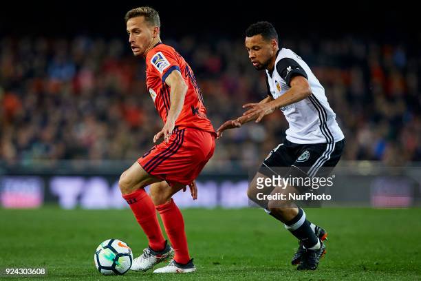 Sergio Canales of Real Sociedad competes for the ball with Coquelin of Valencia CF during the La Liga match between Valencia CF and Real Sociedad at...