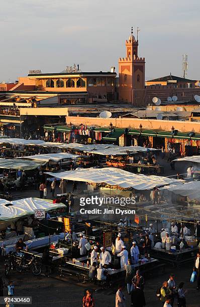 View of a minaret across the market at Jemaa el Fna square, on October 20, 2009 in Marrakech, Morocco.