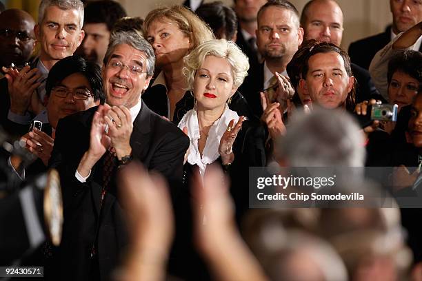 Pop music artist Cyndi Lauper applauds with other human rights advocates during a ceremony marking the enactment of the Matthew Shepard and James...