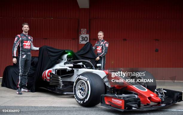 Team's French driver Romain Grosjean and HAAS F1 Team's Danish driver Kevin Magnussen unveil their new VF-18 car during their official presentation...