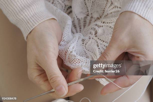 close-up of hands knitting lace for her family - doily stock pictures, royalty-free photos & images