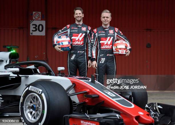 Team's French driver Romain Grosjean and HAAS F1 Team's Danish driver Kevin Magnussen pose by their new VF-18 car during their official presentation...