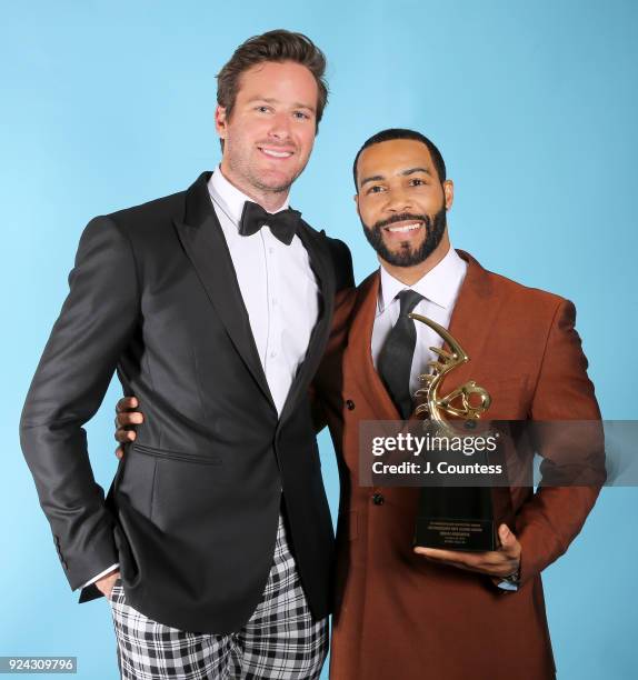 Armie Hammer and Omari Hardwick pose backstage with his award during the 2018 American Black Film Festival Honors Awards at The Beverly Hilton Hotel...