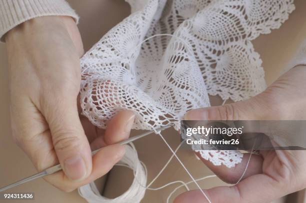 close-up of mother's hands making lace doily - doily stock pictures, royalty-free photos & images