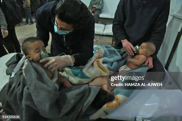 Syrian babies receive treatment for a suspected chemical attack at a makeshift clinic on the rebel-held village of al-Shifuniyah in the Eastern...