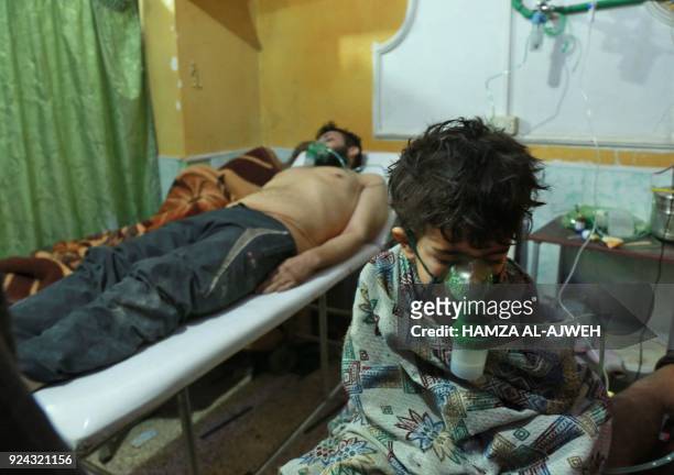 Syrian children and adults receive treatment for a suspected chemical attack at a makeshift clinic on the rebel-held village of al-Shifuniyah in the...