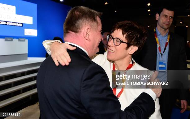 Saarland's state premier Annegret Kramp-Karrenbauer, designated secretary general of the conservative Christian Democratic Union party, hugs outgoing...