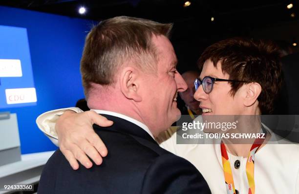 Saarland's state premier Annegret Kramp-Karrenbauer, designated secretary general of the conservative Christian Democratic Union party, hugs outgoing...