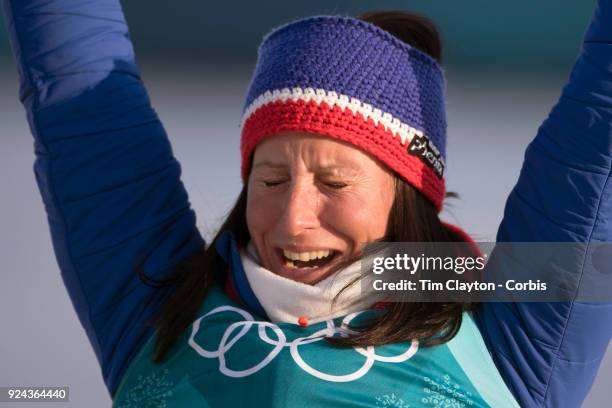 Marit Bjoergen of Norway in tears as she is presented as the gold medal winner of the Cross-Country Skiing - Ladies' 30km Mass Start Classic during...
