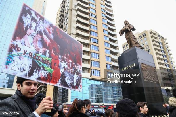 People arrive to place carnations at "Ana feryadi" monument, during the 26th anniversary of 'Khojaly Massacre', which happened in February 1992 when...
