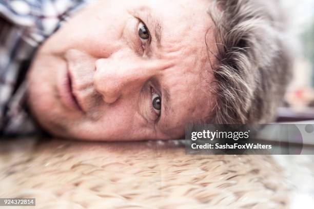 senior man looking depressed - sasha fox stock pictures, royalty-free photos & images