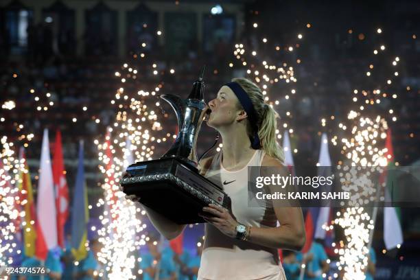 Elina Svitolina of Ukraine kisses the champion's trophy after winning the WTA Dubai Duty Free Tennis Championship on February 24, 2018. / AFP PHOTO /...