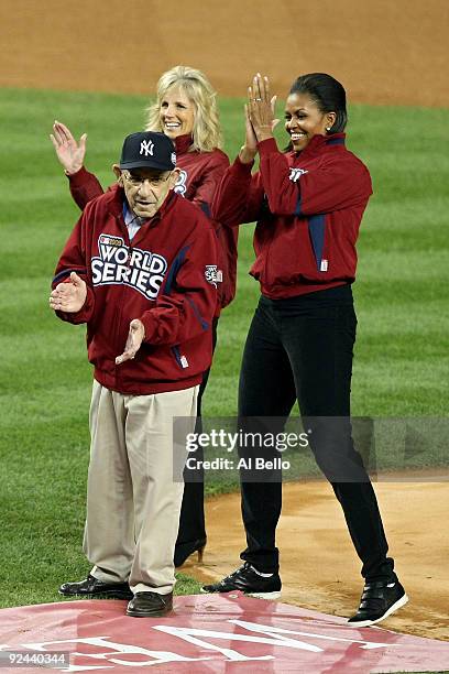 New York Yankees legend and Baseball Hall of Famer Yogi Berra stands on the field with First lady Michelle Obama and Dr. Jill Biden, wife of Vice...