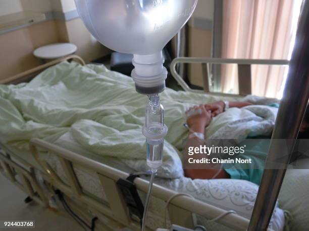 intravenous drip in sick room - hospital bed with iv stock pictures, royalty-free photos & images