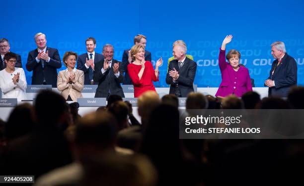 German Chancellor and leader of the conservative Christian Democratic Union party Angela Merkel is applauded by party colleagues Annegret...