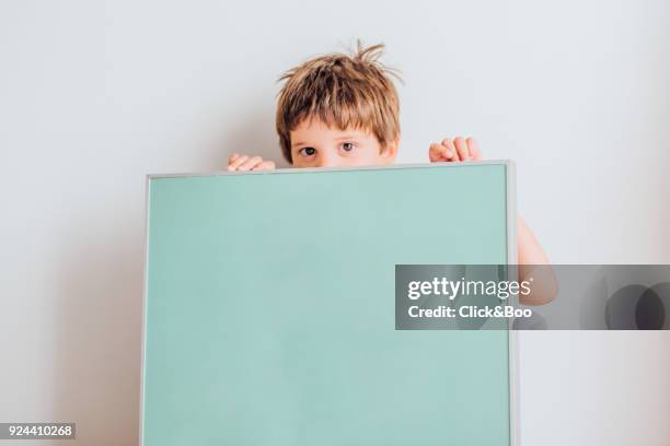 little boy holding a poster - kids placard stock pictures, royalty-free photos & images