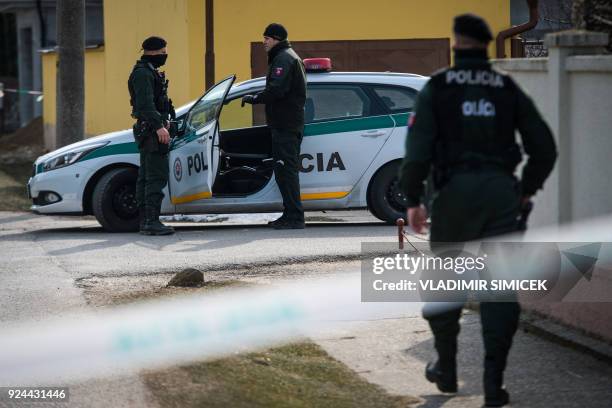 Policemen stand guard at the crime scene where Slovak investigative journalist Jan Kuciak and his girlfriend Marina Kusnirova were murdered in Velka...