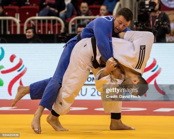 Olympic silver medallist, Varlam Liparteliani of Georgia throws Ben Fletcher of Ireland for an ippon to win the u100kg gold medal during the 2018...